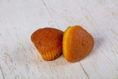 Sweet tasty muffins over wooden backgroundの写真素材