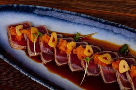 Grilled sliced tuna sashimi with sauceの写真素材