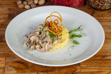 Tasty beef stroganoff with mashed potatoes and herbsの写真素材