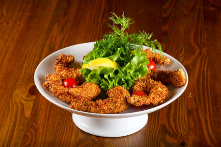 Sesame prawn tempura served lemon and herbs