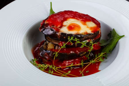 Appetizing eggplant parmigiano with  cheese and tomato sauceの写真素材