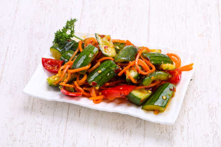 Pickled green cucumbers heap in the bowlの写真素材