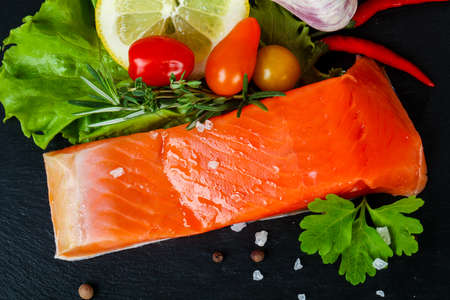 Raw trout fillet with salt and spicesの写真素材