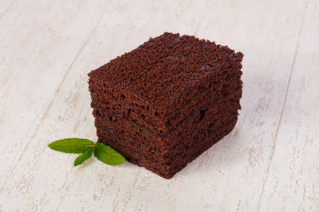 Tasty Sponge cake over wooden background