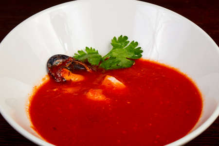 Tomato seafood soup servrd corianderの写真素材