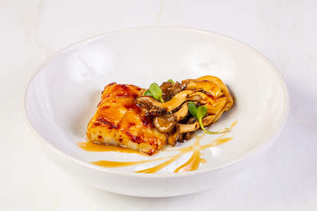 Halibut with mushroom and orange sauce