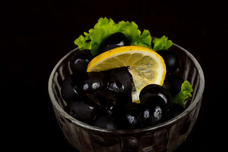 Black olives in the bowl served lemonの写真素材