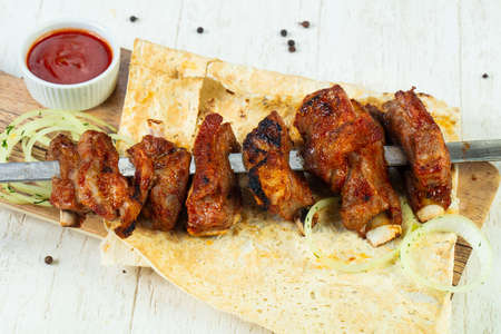 Lamb ribs bbq with onion and sauceの写真素材