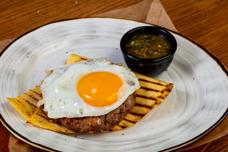 Beef cutlet with egg and sauce