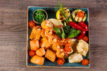 Fish and prawn plate served grilled vegetablesの写真素材