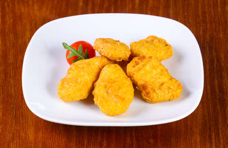 Chicken nuggets heap served cherry tomatoの写真素材