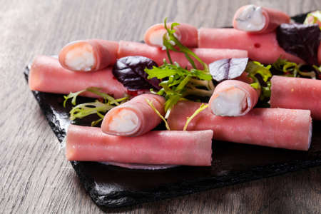 Ham stuffed cheese roll on the plateの写真素材