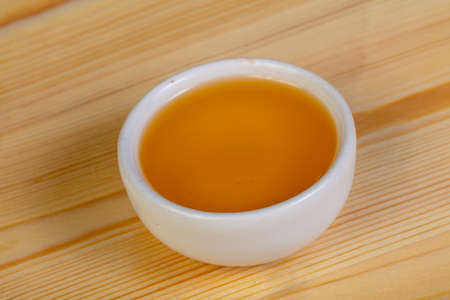 Honey in the bowl over the wooden background