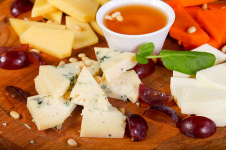 Cheese plate with honey and cedar nutsの写真素材