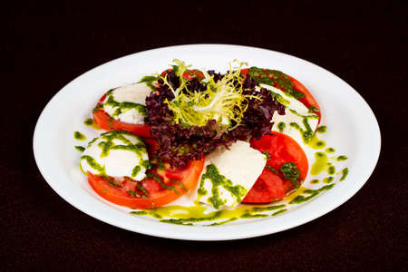 Italian Caprese salad with pesto and mozarellaの写真素材