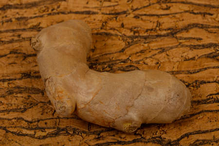 Ginger root over the wooden background