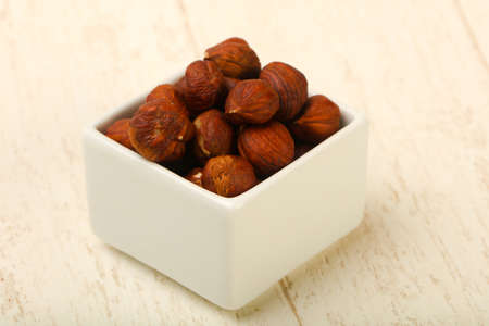 Hazelnut heap over the wooden backgroundの写真素材