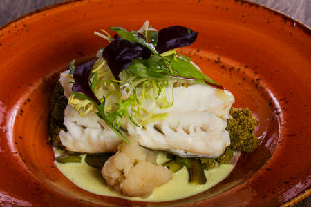Steamed fish with salad leaves