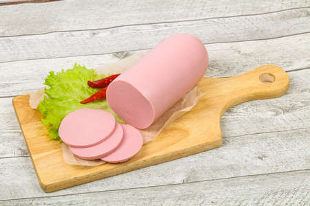 Sliced pork sausage with salad leavesの写真素材