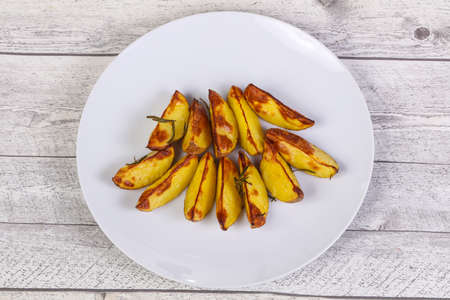 Baked potato pieces with rosemary