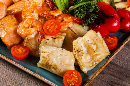 Fish and prawn plate served grilled vegetablesの写真素材