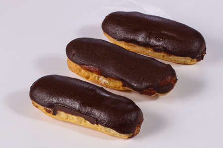 Tasty eclair with cream and chocolate