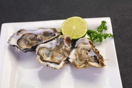 Fresh Oysters with lime and parsleyの写真素材