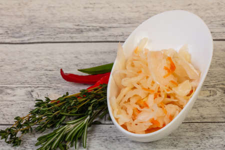 Pickled cabbage - sauerkraut with thyme and rosemaryの写真素材