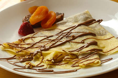 Pancake with chocolate and dried fruitsの写真素材