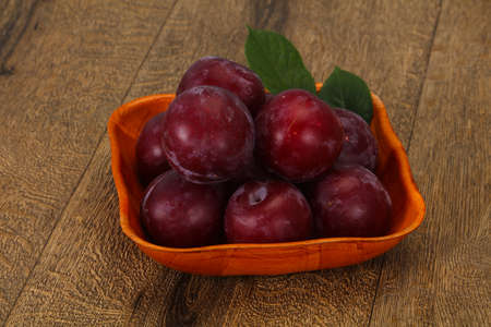 Ripe Plum heap in the wooden basketの写真素材