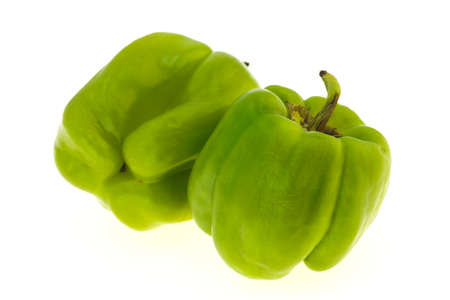 Two Green bell pepper isolated on white backgroundの写真素材