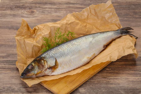 Salted herring over the wooden board with dillの写真素材