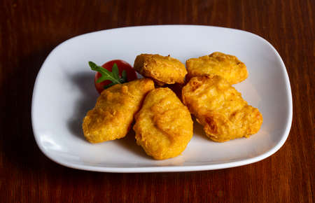 Chicken nuggets heap served cherry tomato