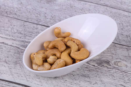 Tasty cashew nuts heap in the bowlの写真素材