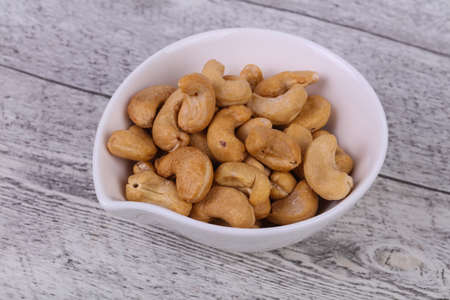 Tasty Cashew nuts heap in the bowlの写真素材