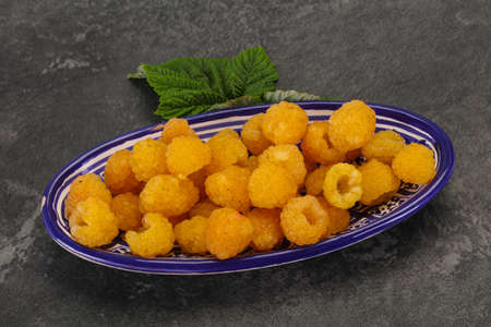 Sweet ripe tasty yellow raspberry with leaf
