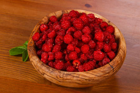 Wild raspberry in the wooden bowlの写真素材