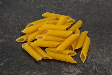 Raw penne pasta ready for bowlの写真素材