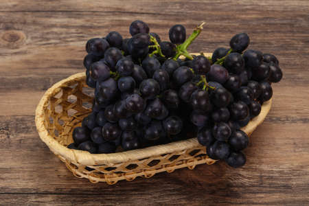 Fresh ripe sweet red grape on the branchの写真素材