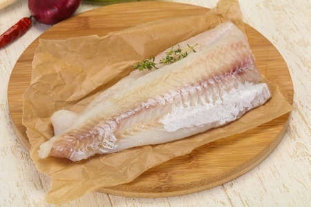 Pollack fillet raw ready for cooking over wooden