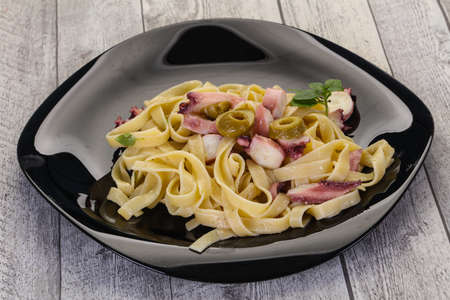 Pasta with octopus and olivesの写真素材