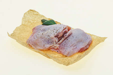 Raw chicken hip with spices isolated on white backgroundの写真素材