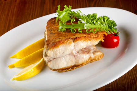 Baked salmon served lemon and herbs