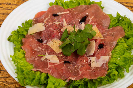 Beef carpaccio with parmesan cheese and salad leavesの写真素材