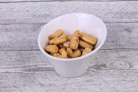 Tasty Cashew nuts heap in the bowlの写真素材