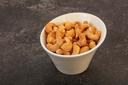 Roasted Cashew heap in the bowlの写真素材