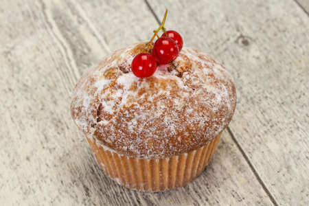 Sweet tasty muffin with red currants berriesの写真素材