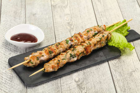 Minced pork skewer kebab with bbq sauceの写真素材