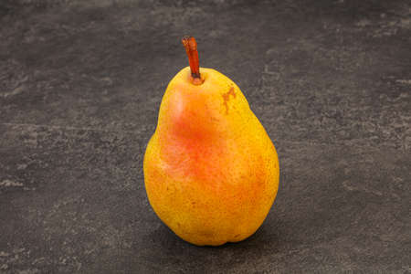 Fresh sweet yellow pear over backgroundの写真素材