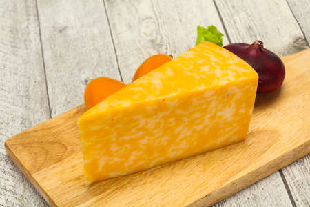 Marble cheese  triangle over wooden backgroundの写真素材